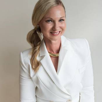 Douglas S Harrington MD vilkintis juodą smokingą ir varlytę, stovi priešais banerį su logotipais, įskaitant Oscars ir HeartDaHeart Foundation, oficiali renginio aplinka, neutralus ir profesionalus įspūdis, matomas tekstas: Oscars HeartDaHeart Foundation UnmaskHeartDisease